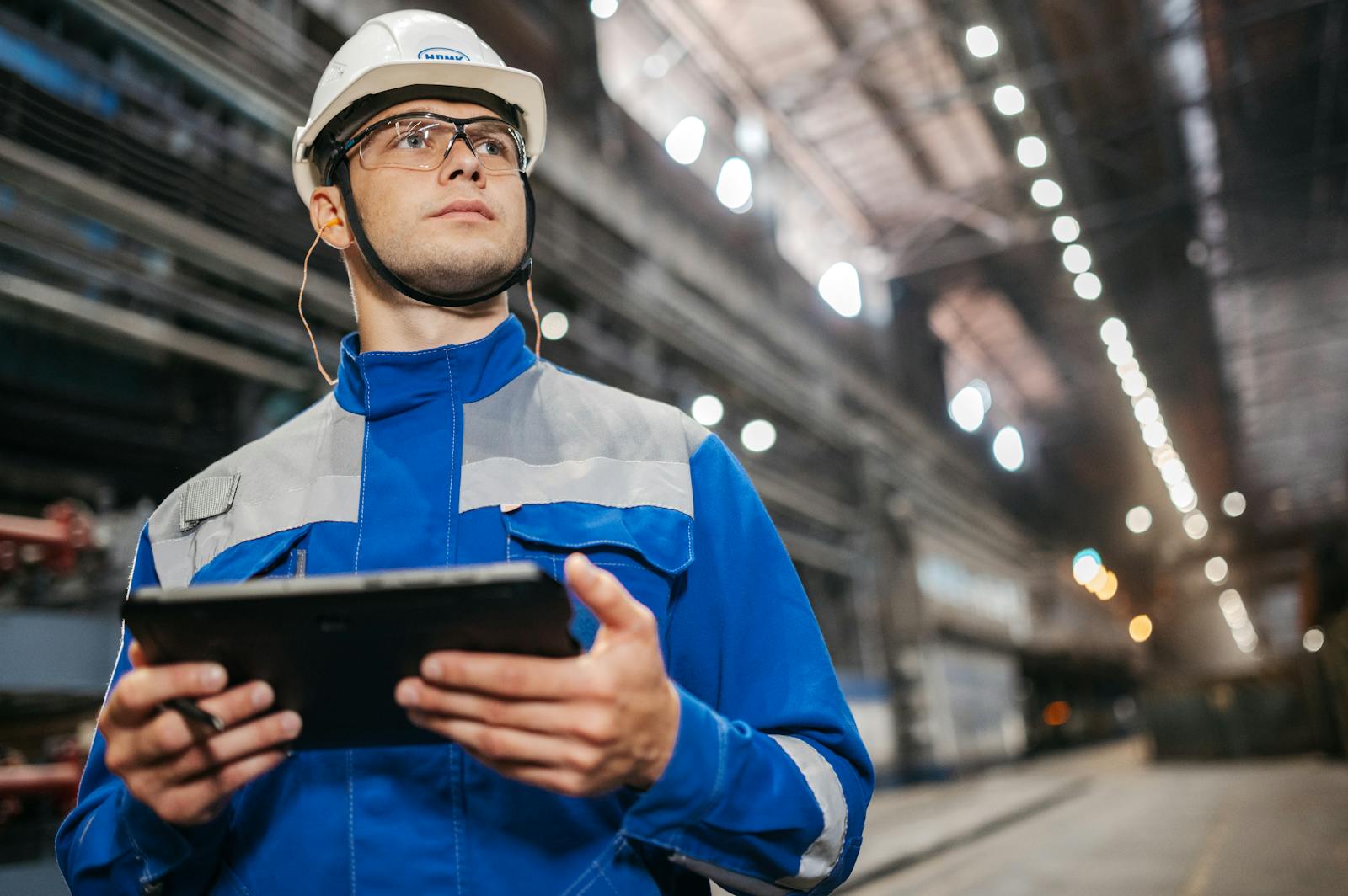 Factory operator using a tablet on a production floor